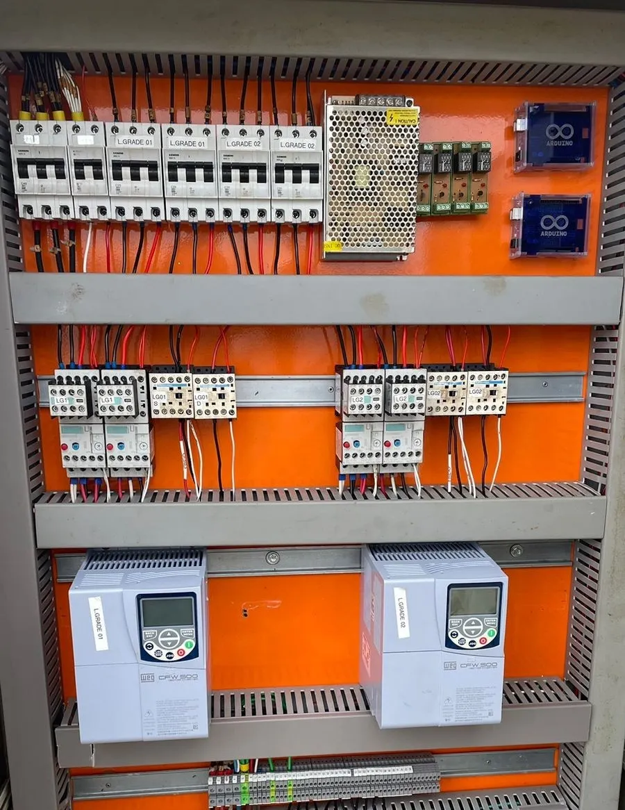 Painel com dois inversores de frequência WEG CFW500 identificados como L.GRADE 01 e L.GRADE 02, disjuntores Siemens, contatores e módulo de relés com duas placas Arduino.